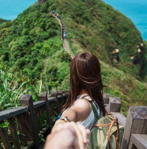 Couple traveler visiting in Taiwan, Tourist sightseeing in Bitou Cape Hiking Trail, New Taipei City. landmark and popular attractions near Taipei. trip, love, together and summer vacation concept